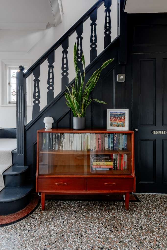 Staircase with black gloss spindles and panelled door